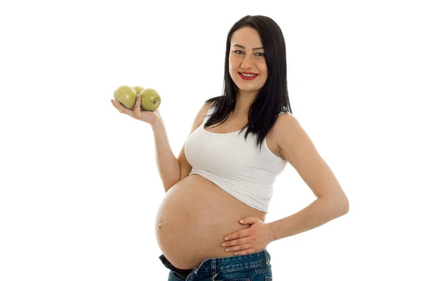 Cheerful pregnant brunette girl in big belly posing isolated on white background — Stock Photo, Image