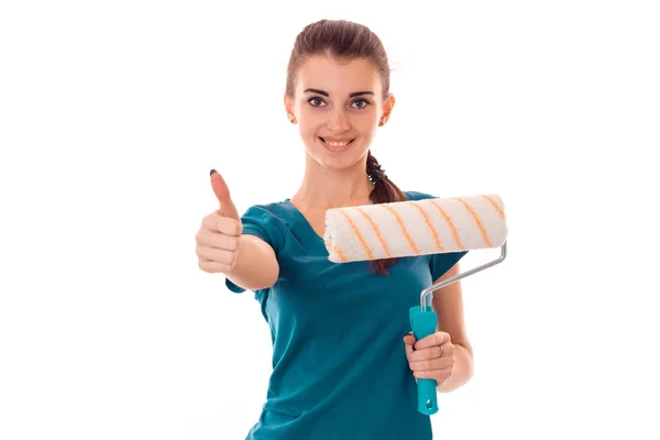 Cheerful young girl in uniform makes renovation isolated on white background Stock Picture