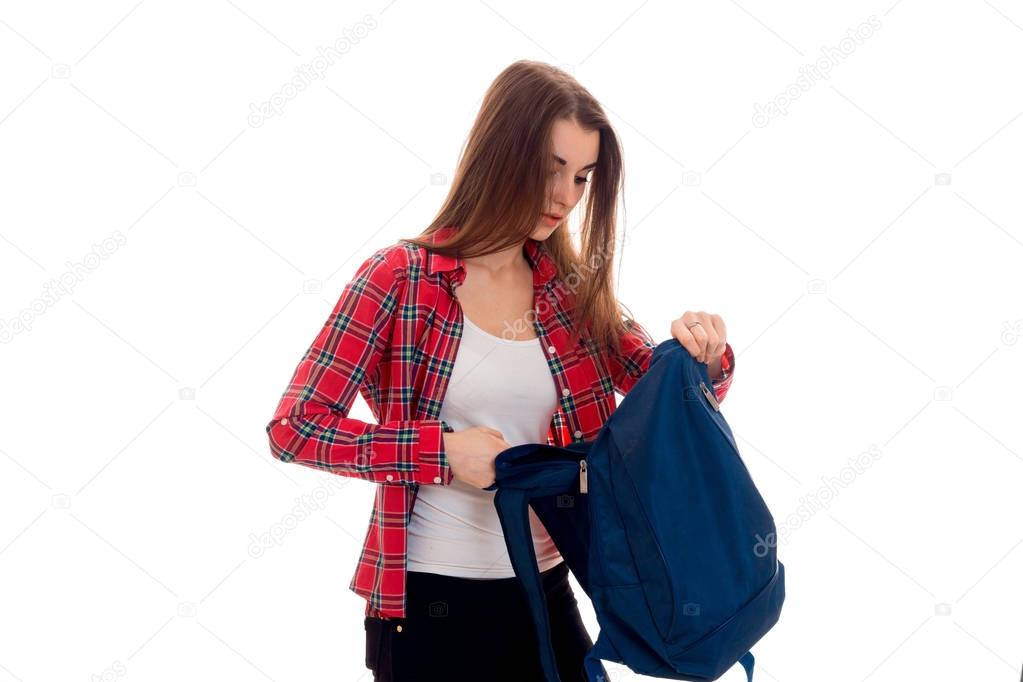 pretty young brunette students teenager in stylish clothes and backpack in her hands posing isolated on white background