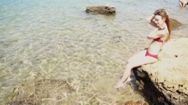 rock ve flop ayaklarda su kız kırmızı mayo oturur