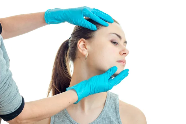 Cosmetologist ελέγχει τα χέρια με γάντια πρόσωπο μιας νεαρής γυναίκας — Φωτογραφία Αρχείου