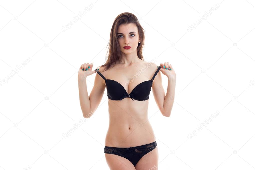 young beautiful girl in sexy underwear stands up straight and posing for the camera
