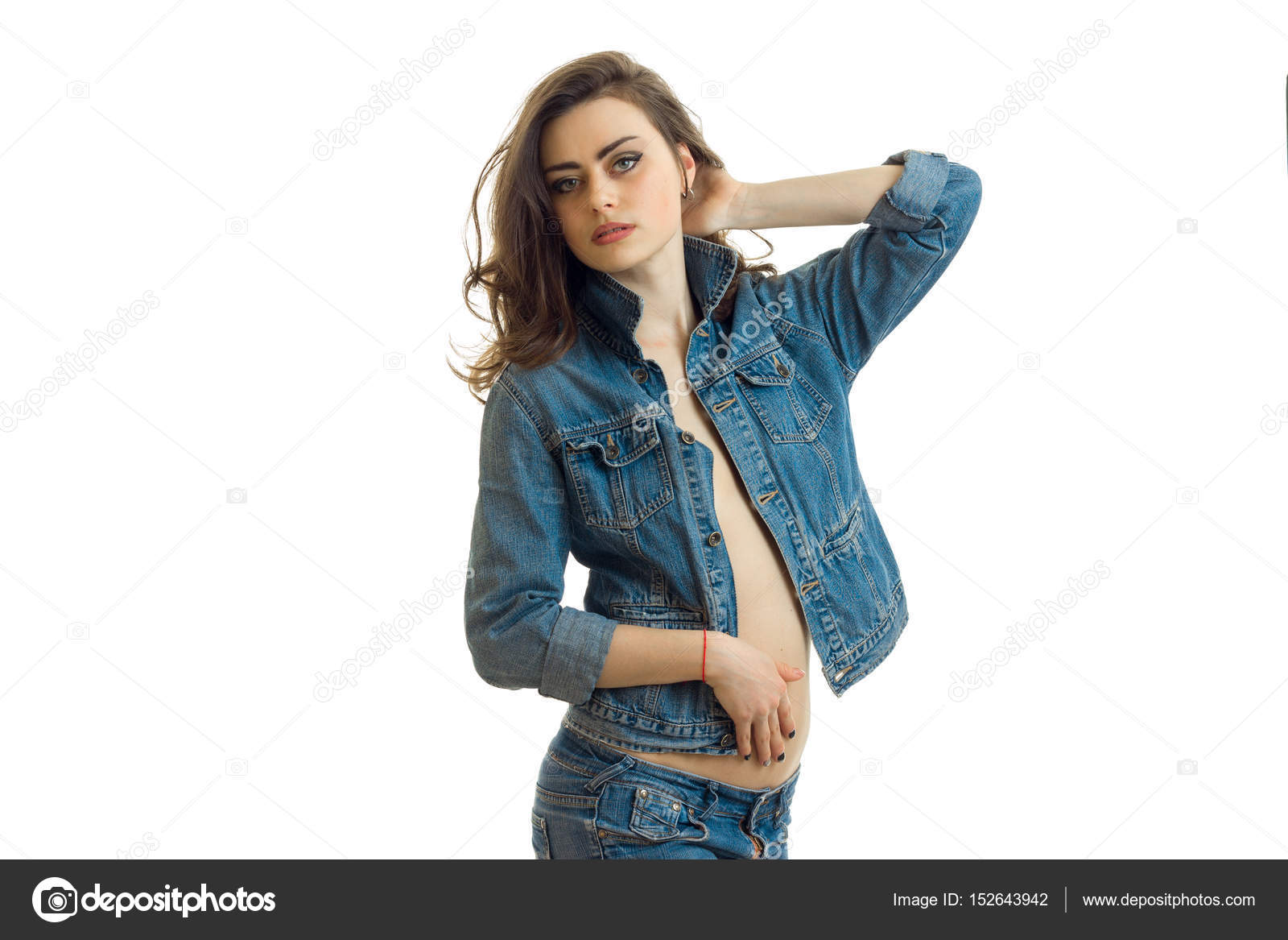 Charming brunette in jeans clothes keeps the arm near the hair and looks into the distance Stock Photo by ©ponomarencko 152643942 Charming brunette in jeans clothes keeps the arm near the hair and looks into the distance Stock Photo by ©ponomarencko 152643942