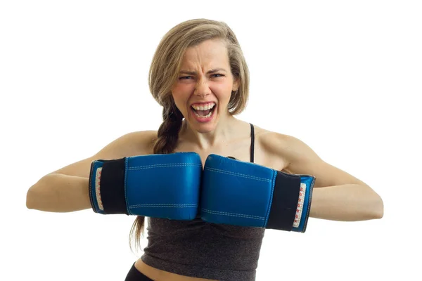 Una joven atlética grita y toma de la mano en guantes de boxeo antes de aislado sobre fondo blanco — Foto de Stock