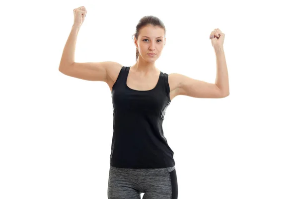 A young athletic girl in black t-shirt had raised two hands up — Stock Photo, Image