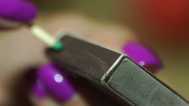 Girl with the purple manicure lights a match in slow motion — Stock Video