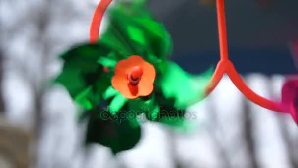 Green toy windmill is spinning from the wind — Stock Video