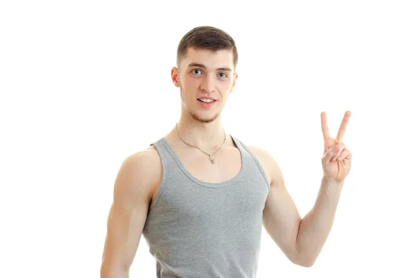 Guy looks into the camera and hand gesture with raised up two fingers — Stock Photo, Image