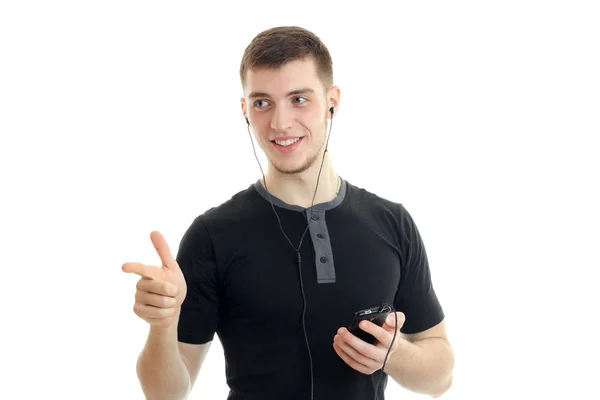 Hilarious charming guy in the black shirt looks to the side and shows finger — Stock Photo, Image