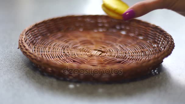 Girl makes macaroon cookie Tower in plate — Stock Video