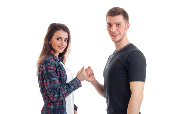 Vackra leende flicka och en ung homosexuell kille håller varandra för små fingrar närbild — Stockfoto