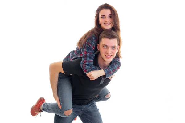 Joyful young girl on shoulders by the beautiful fun guy — Stock Photo, Image