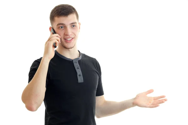 Handsome young man talking phone and smiling — Stock Photo, Image