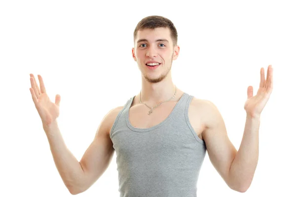 Felice giovane uomo mostrando qualcosa di grande con le mani e sorridente sulla macchina fotografica — Foto Stock