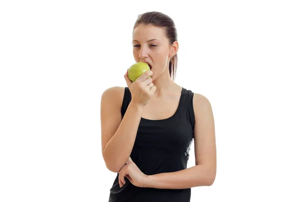 Retrato horizontal de una joven con una camiseta negra que come Apple — Foto de Stock