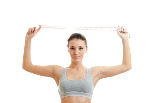 Horizontal portrait of a young girls sports which keeps the head over the measuring tape — Stock Photo, Image