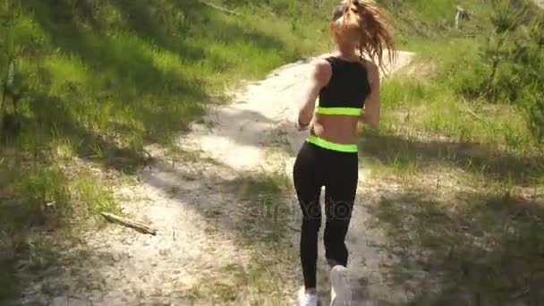 Молодая спортивная девушка в форме бежит — стоковое видео