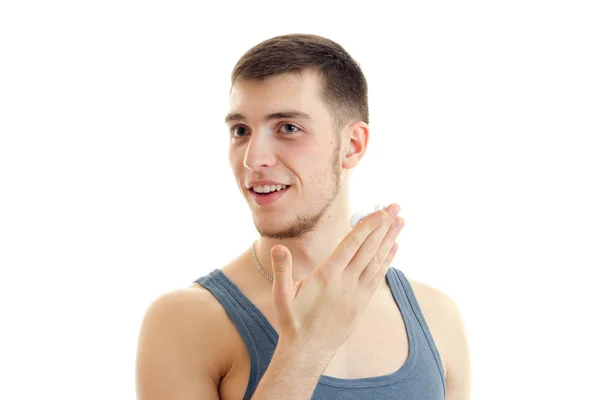 Close-up portrait of a young handsome guy who smiles and holds the Palm near the face — Stock Photo, Image