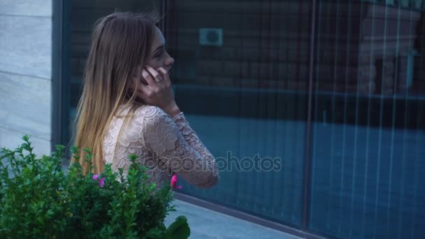 Bela loira senhora senta-se na rua e fala de telefone celular — Vídeo de Stock