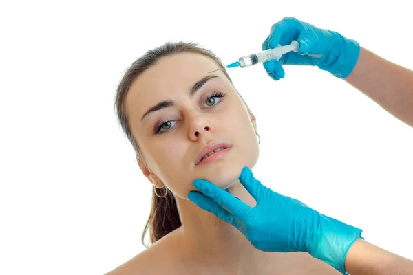 A close-up portrait of beautiful girls which the doctor makes incisions on the face — Stock Photo, Image