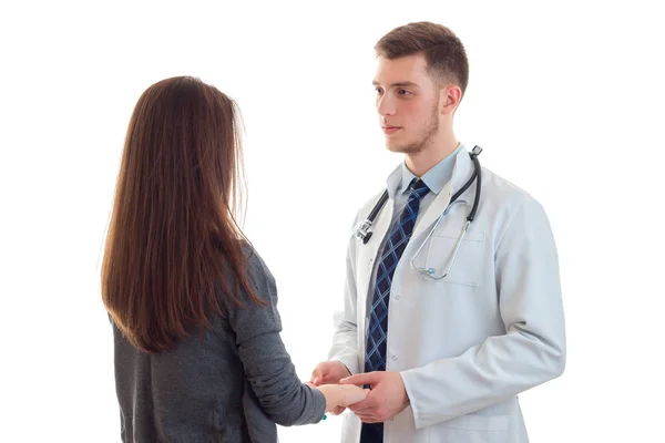 Doctor in uniform holds his patients hand and looking at her — Stock Photo, Image