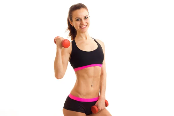 Cheerful woman in sport uniform with dumbbells in hands smiling — Stock Photo, Image