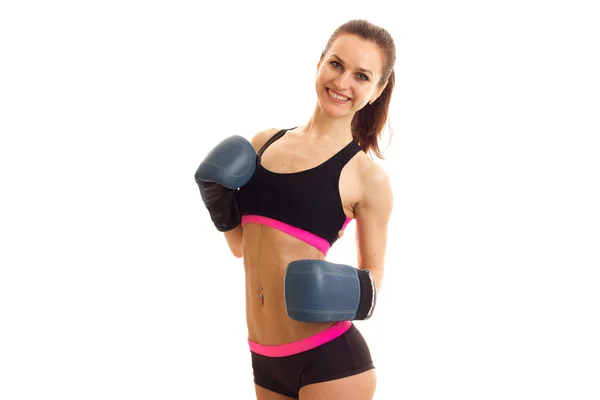 Pretty young woman in sports uniform and boxing gloves smiling — Stock Photo, Image