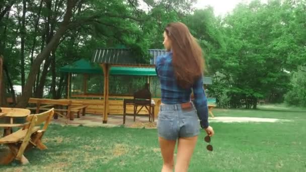 Горячая леди в коротких джинсовых шортах выходит на улицу — стоковое видео