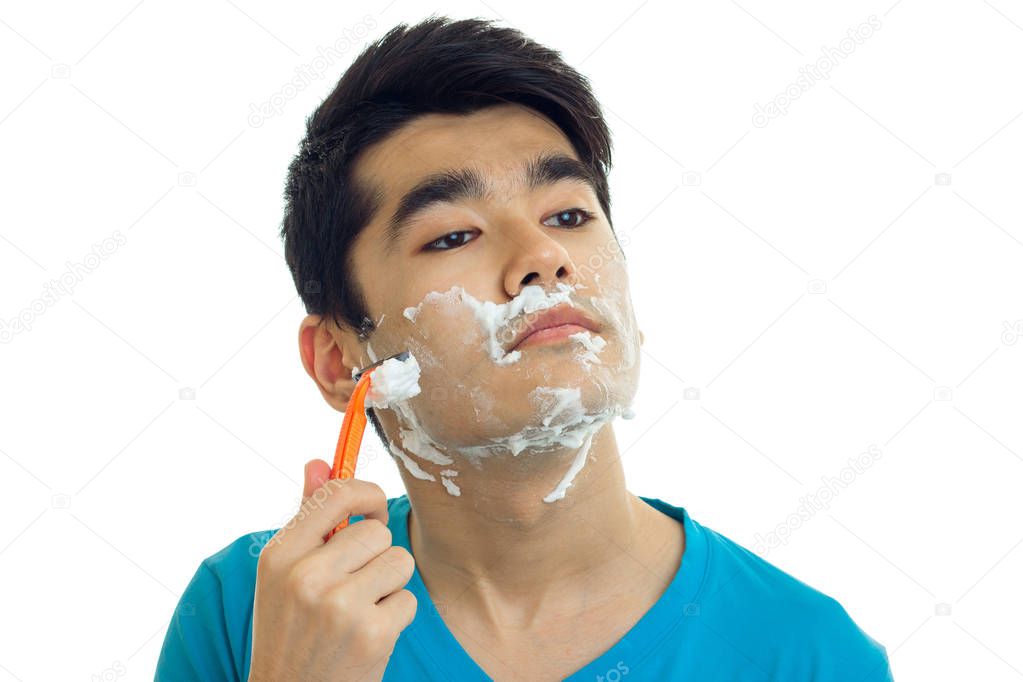 man with facial foam shaves