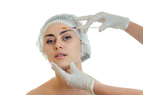 Horizontal portrait of a young girl at the doctor who gloved introduces vaccine on face — Stock Photo, Image