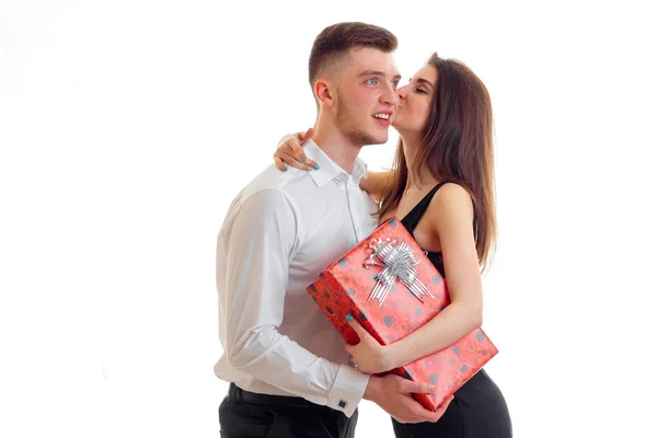 Roztomilá dívka líbání kluka v tom, že on ji přinesl dárek izolovaných na bílém pozadí — Stock fotografie