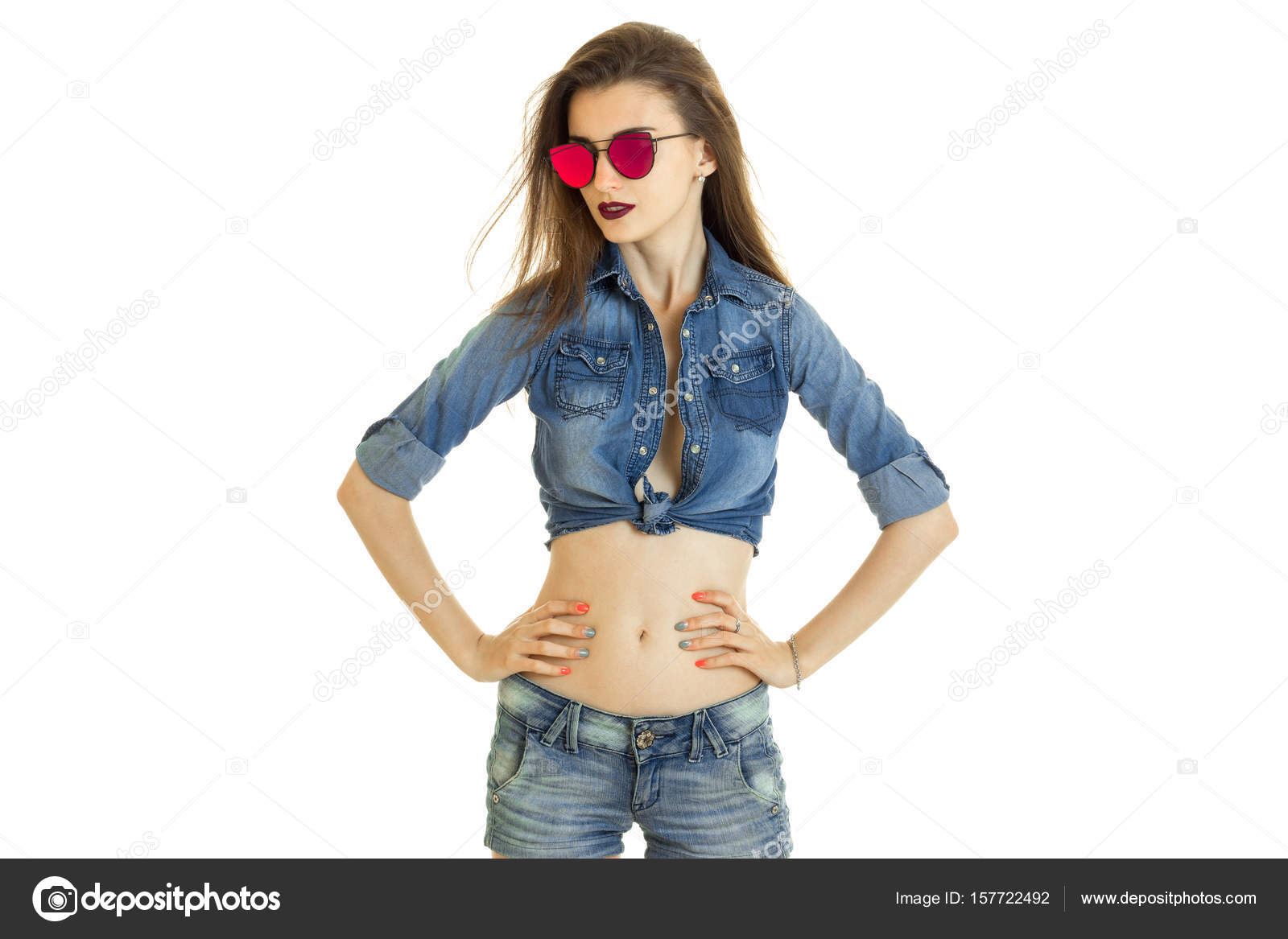 Glamour young lady in denim clothes and sunglasses without bra