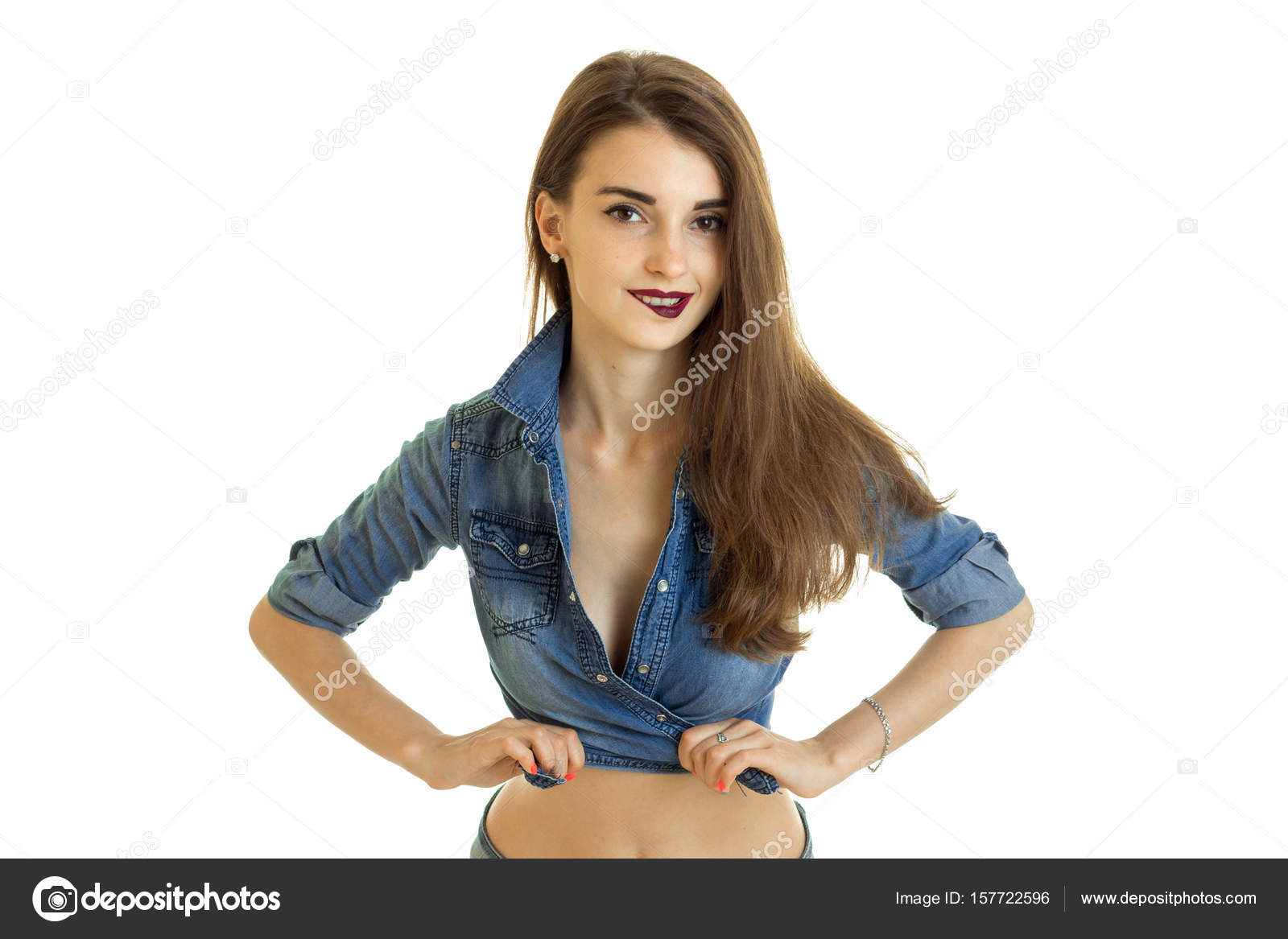 Cutie young girl in jeans t-shirt without bra bite a lips Stock Photo by  ©ponomarencko 157722596