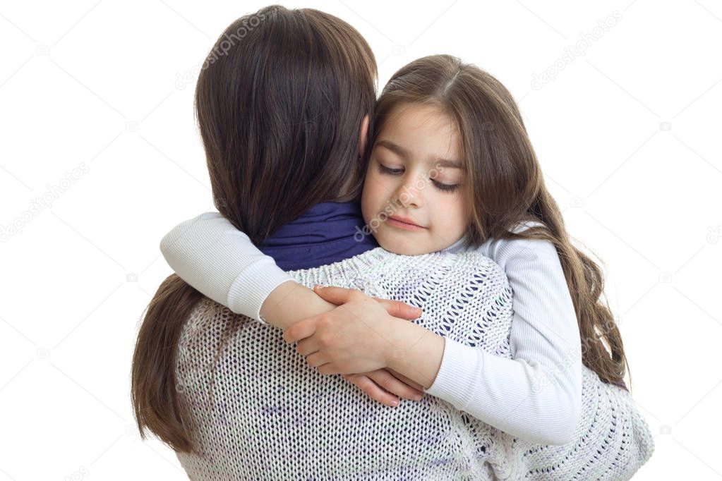 mom hugs her little daughter