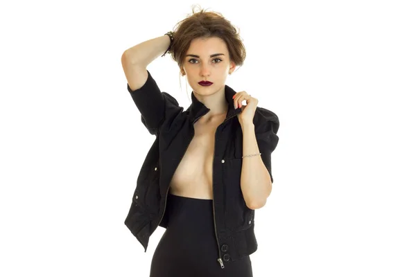 Sexy lady with beautiful silicon breasts in black jacket looks at the camera — Stock Photo, Image