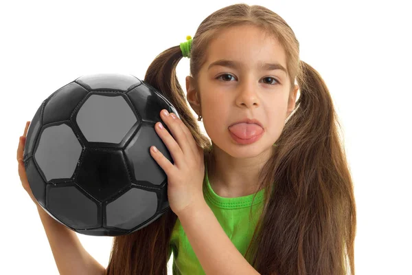 Close-up portrait of a little girl who holds the ball and shows language — Stock Photo, Image