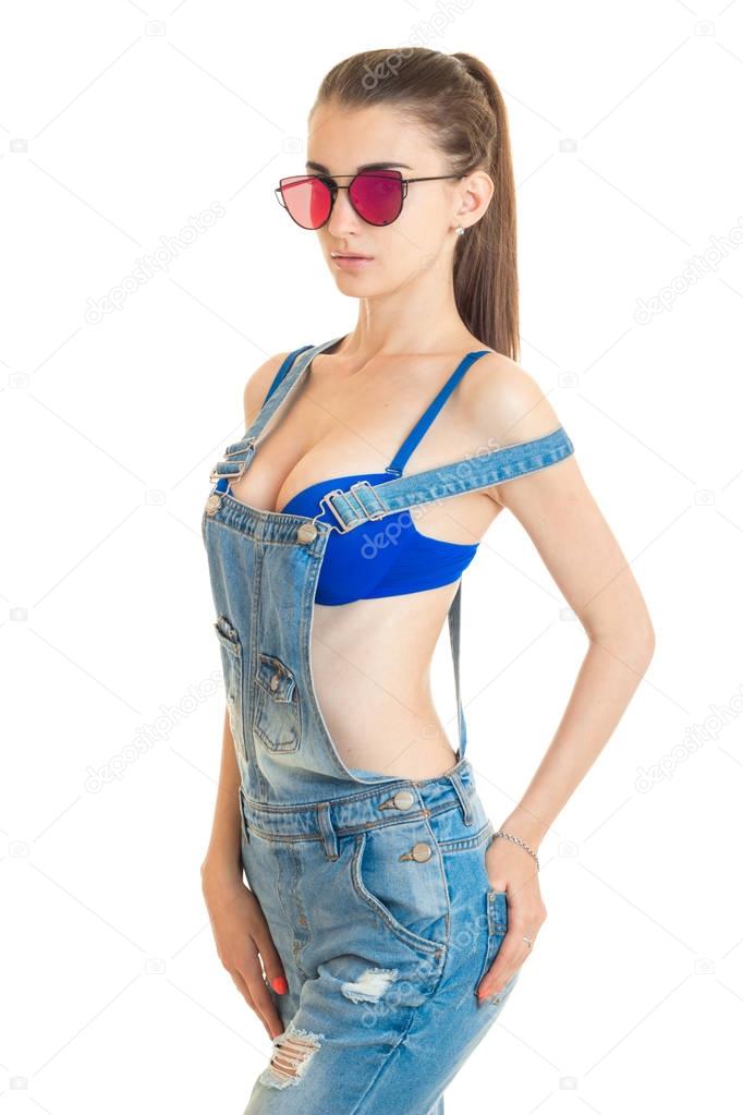 vertical portrait slim sexy women in bright glasses bra and jeans jumpsuit