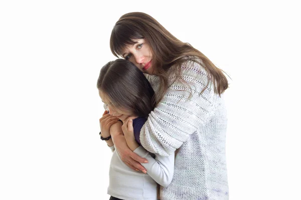 Jovem concurso mãe abraça seu filho no estúdio — Fotografia de Stock