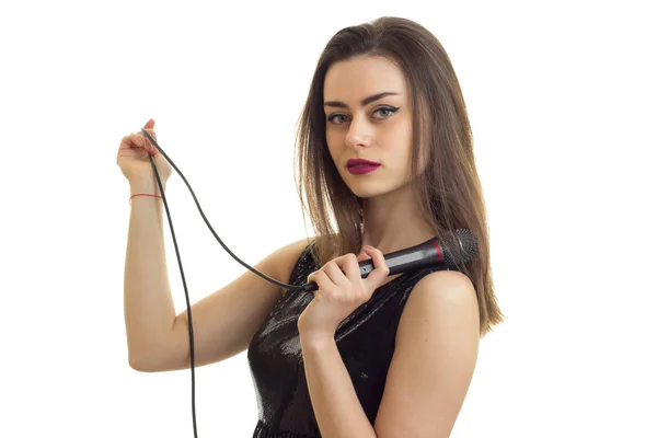 Sexy jonge meisje houdt van een microfoon van karaoke geïsoleerd op een witte achtergrond — Stockfoto