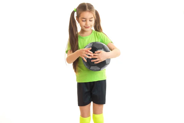 Little baby-girl in a bright t-shirt and tails holds ball in Studio — Stock Photo, Image