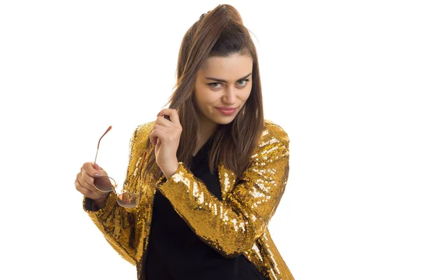 Pretty stylish brunette in golden jacket posing on camera — Stock Photo, Image
