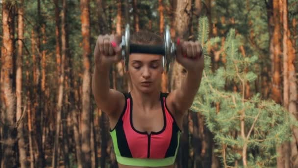 O tânără fată atletică în aer liber agită cu încăpățânare înapoi — Videoclip de stoc