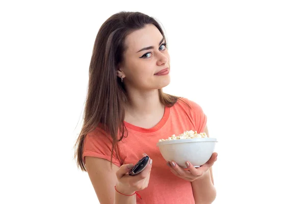 Portrait of a pretty girl with remote control in hand, and pop-corn — Stock Photo, Image