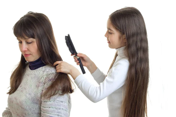 Little girl makes her mom hairstyle — Stock Photo, Image