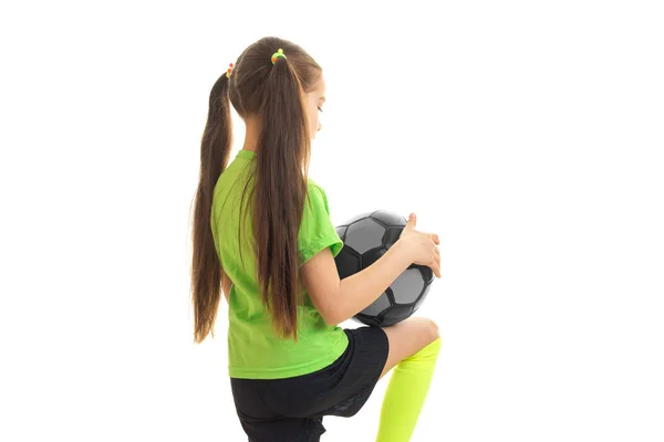 Carino bambina in uniforme verde giocare a calcio — Foto Stock