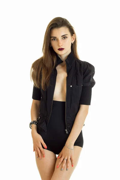 Serious young woman in black jacket and high panties looking at the camera — Stock Photo, Image