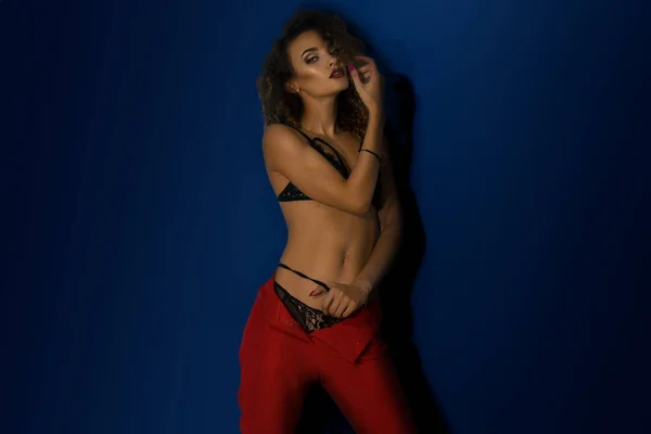 Horizontal portrait of sexual girl in red pants and underwear — Stock Photo, Image