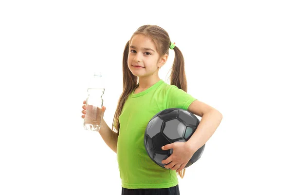 Little firl after football practicing drinks a water — Stock Photo, Image