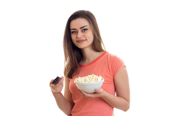 Lovely young woman with tv remote and pop-corn watching movies — Stock Photo, Image