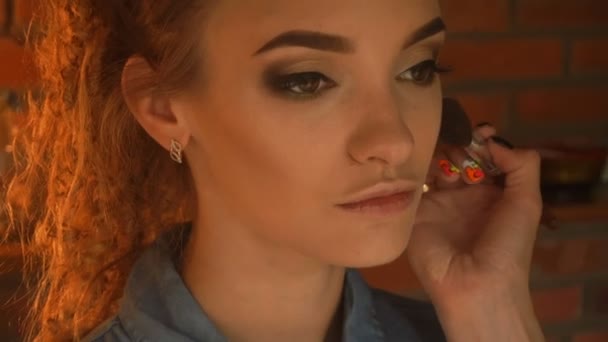 Maquillaje artista ofertas en las mejillas jóvenes resaltador — Vídeos de Stock